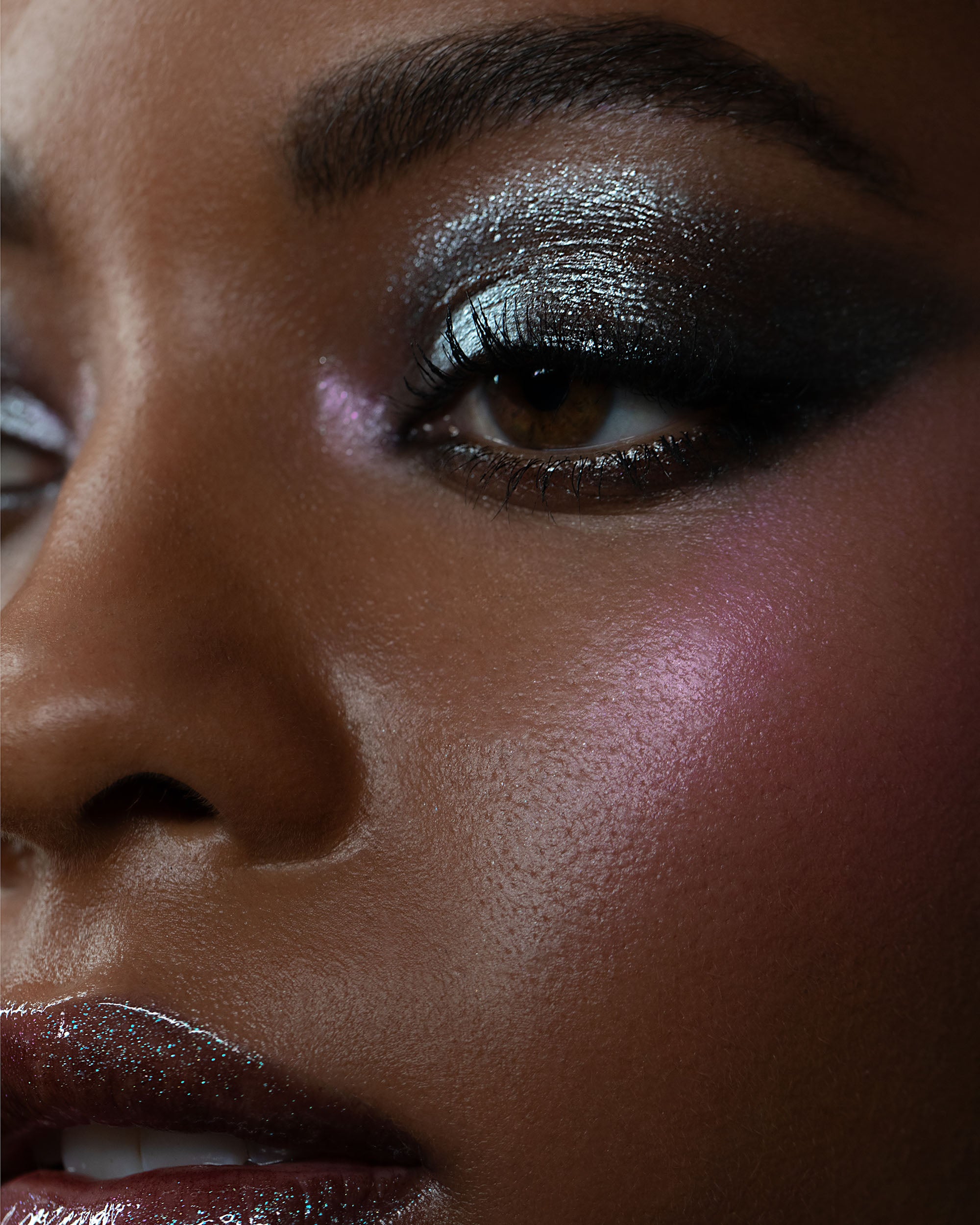Close-up of a person's face with glittery eye makeup