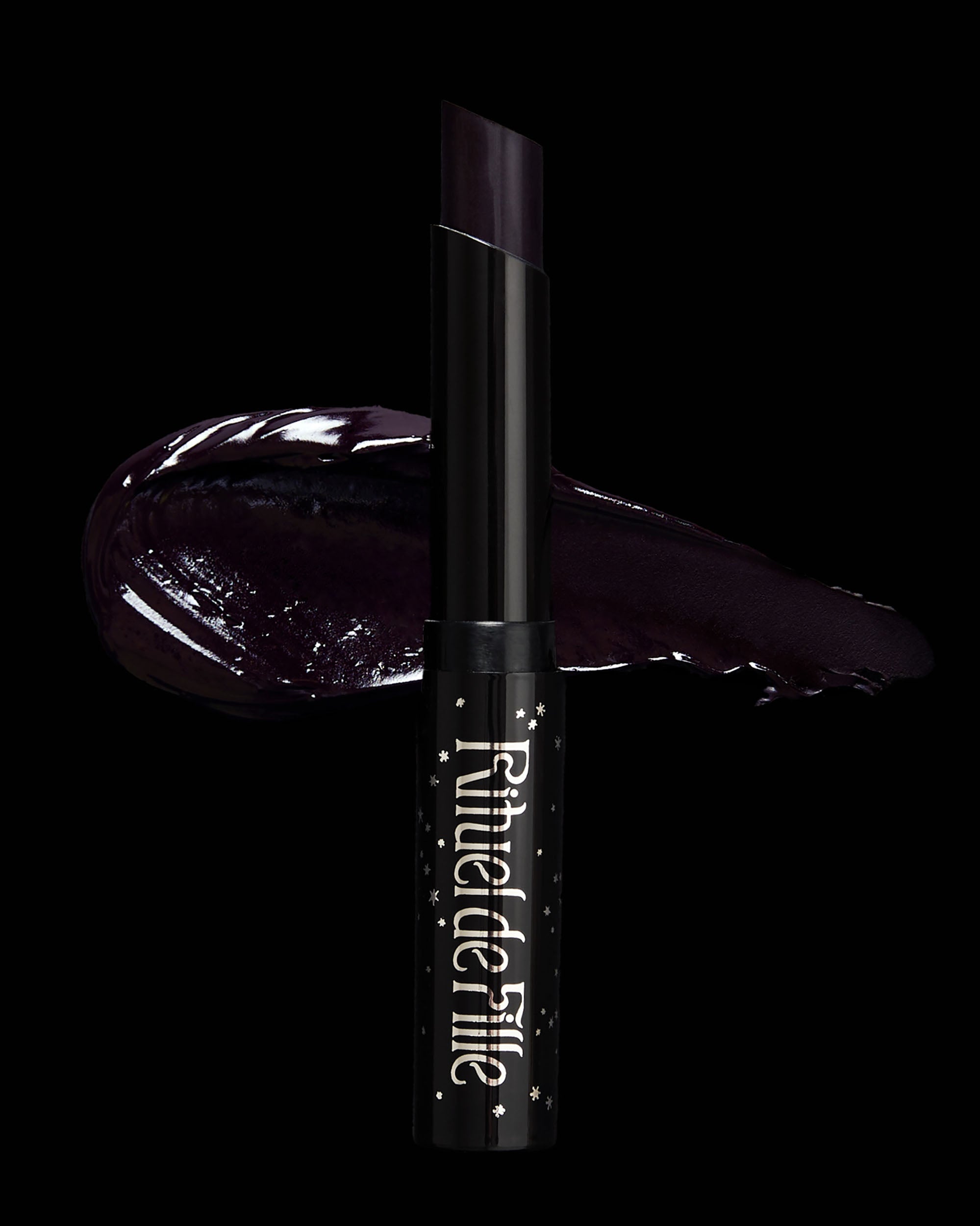 Dark purple lipstick with brand name on a black background