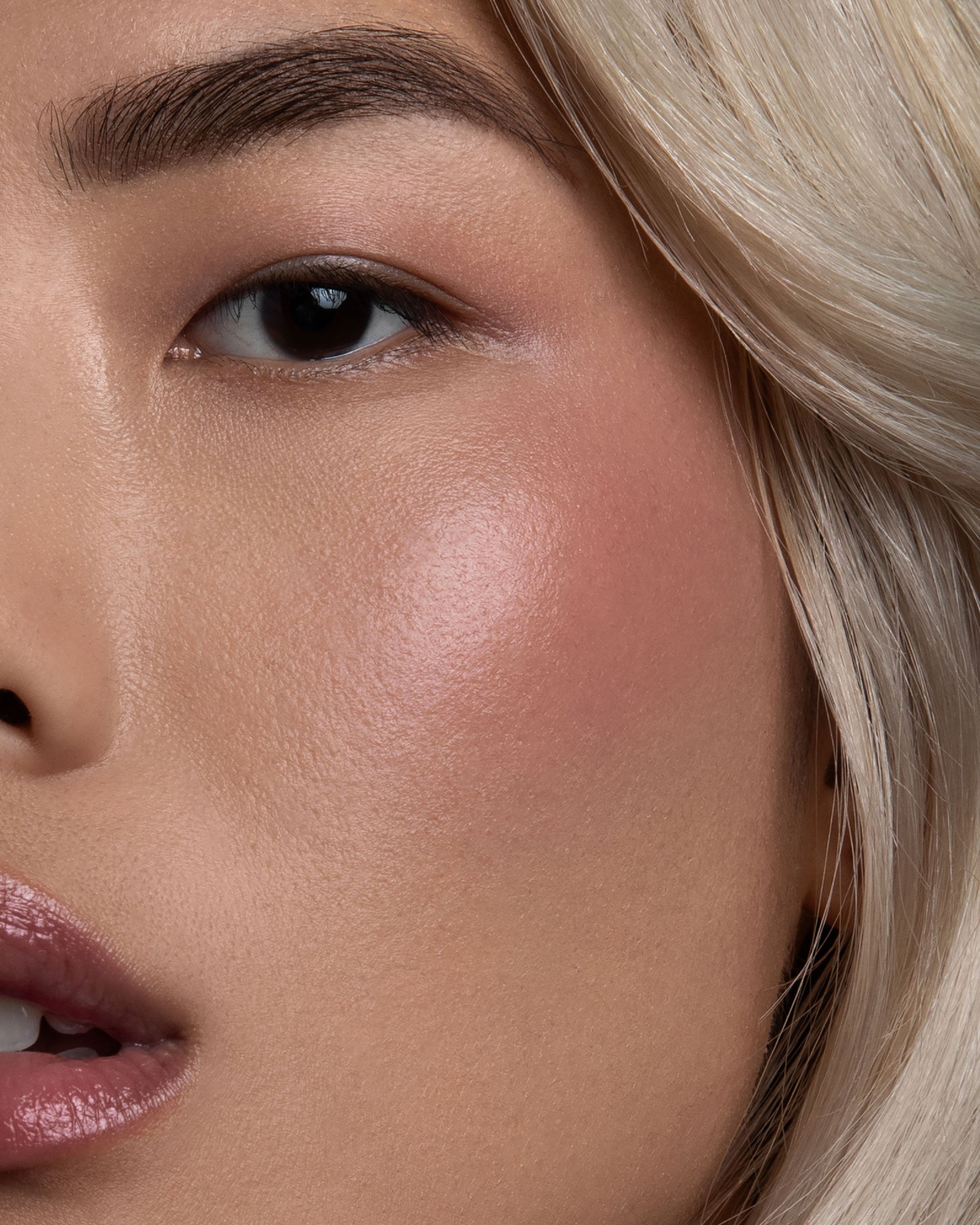 Close-up of a person's face with a focus on the cheek area.