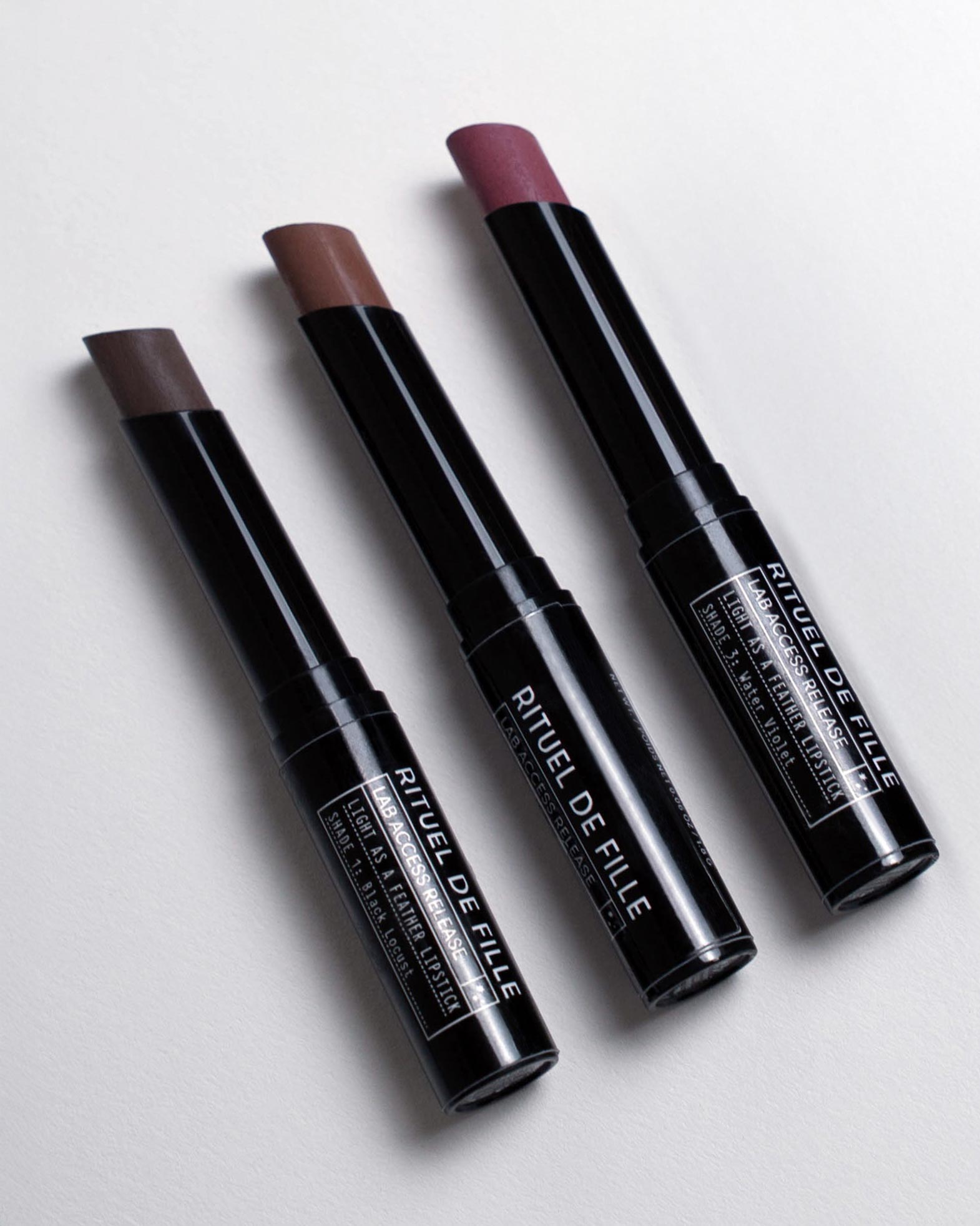 Three lipsticks from Rituel de Fille on a light gray background