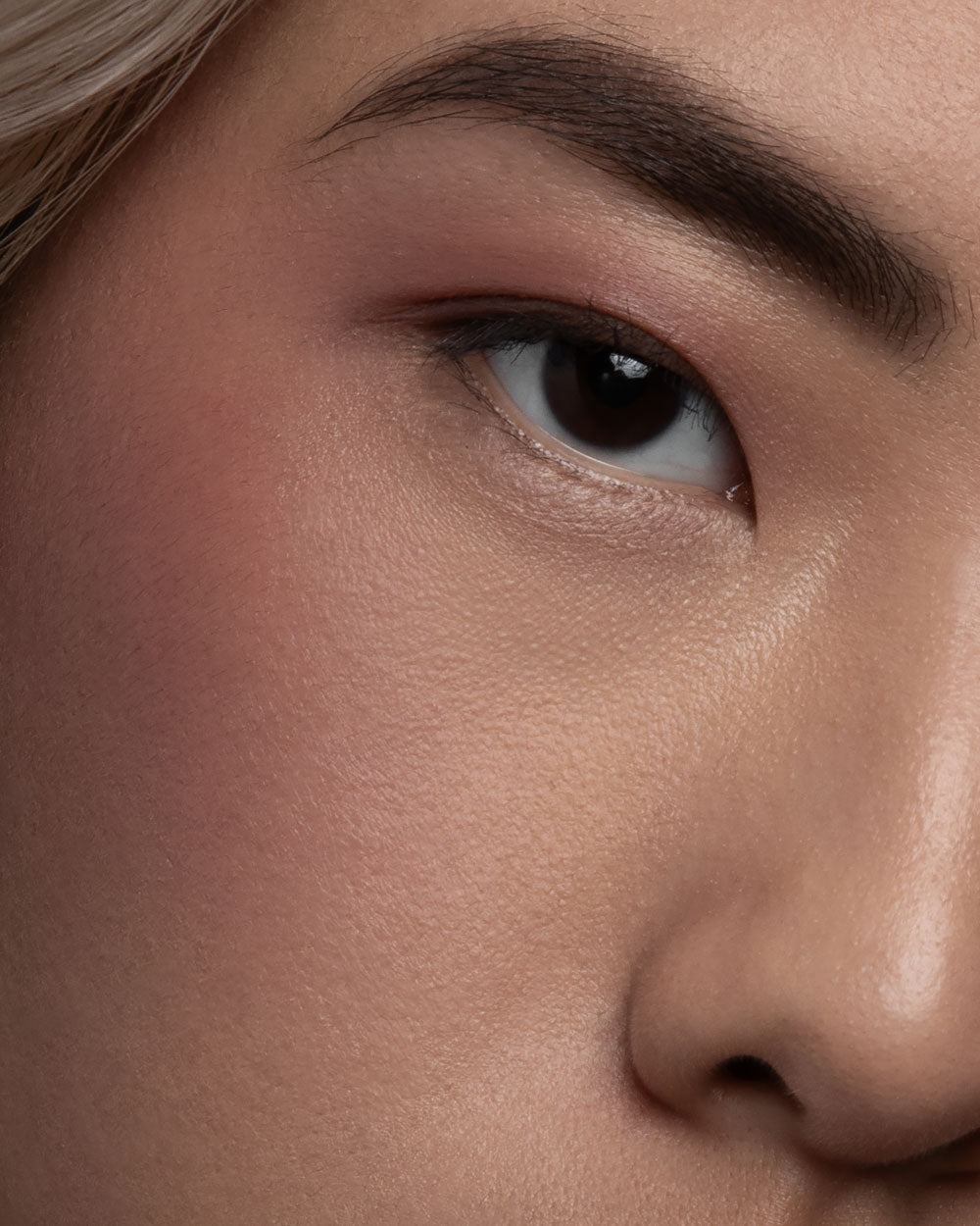 Close-up of a person's eye with a neutral background