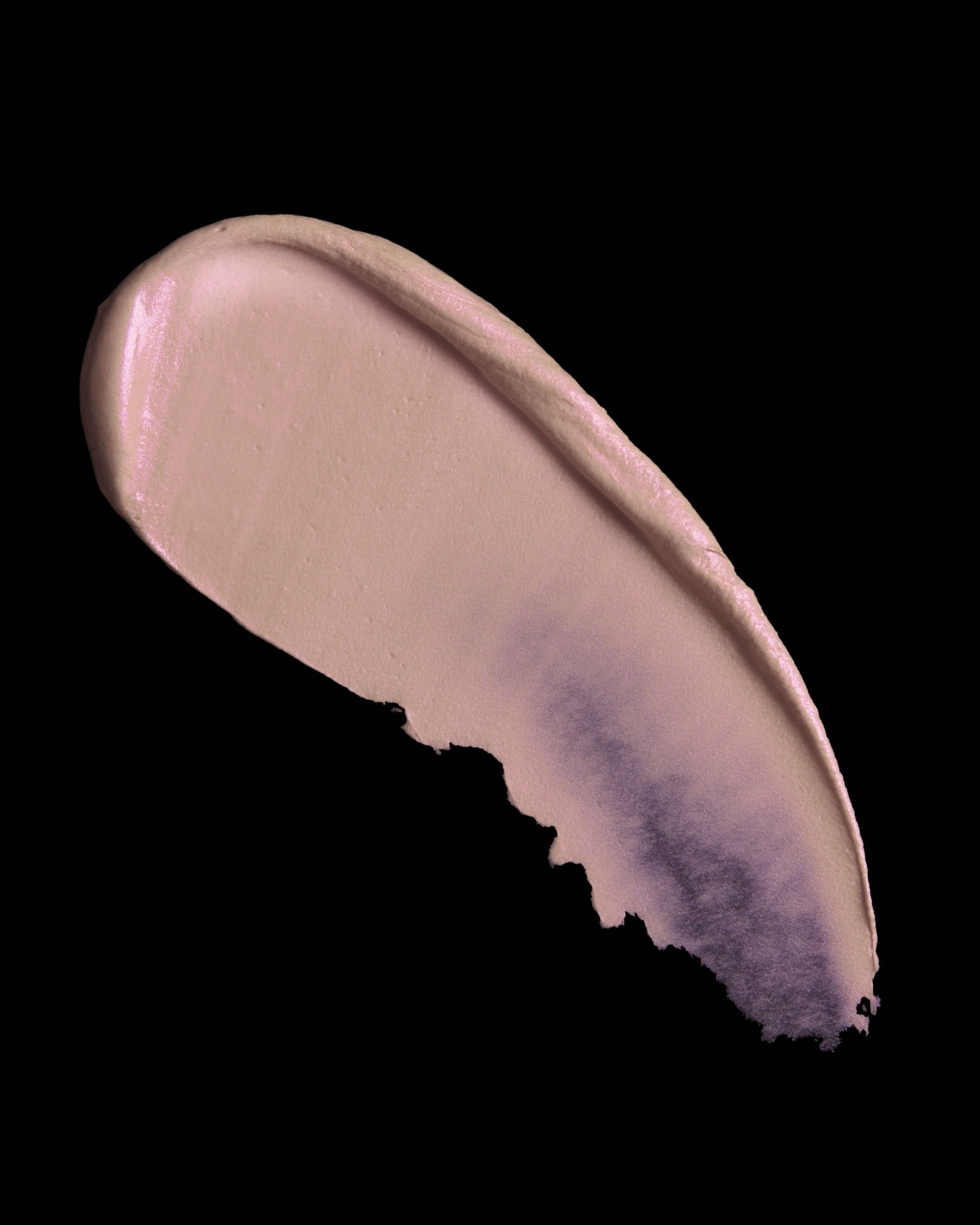 Cosmetic swatch of pink and purple highlighter makeup on a black background