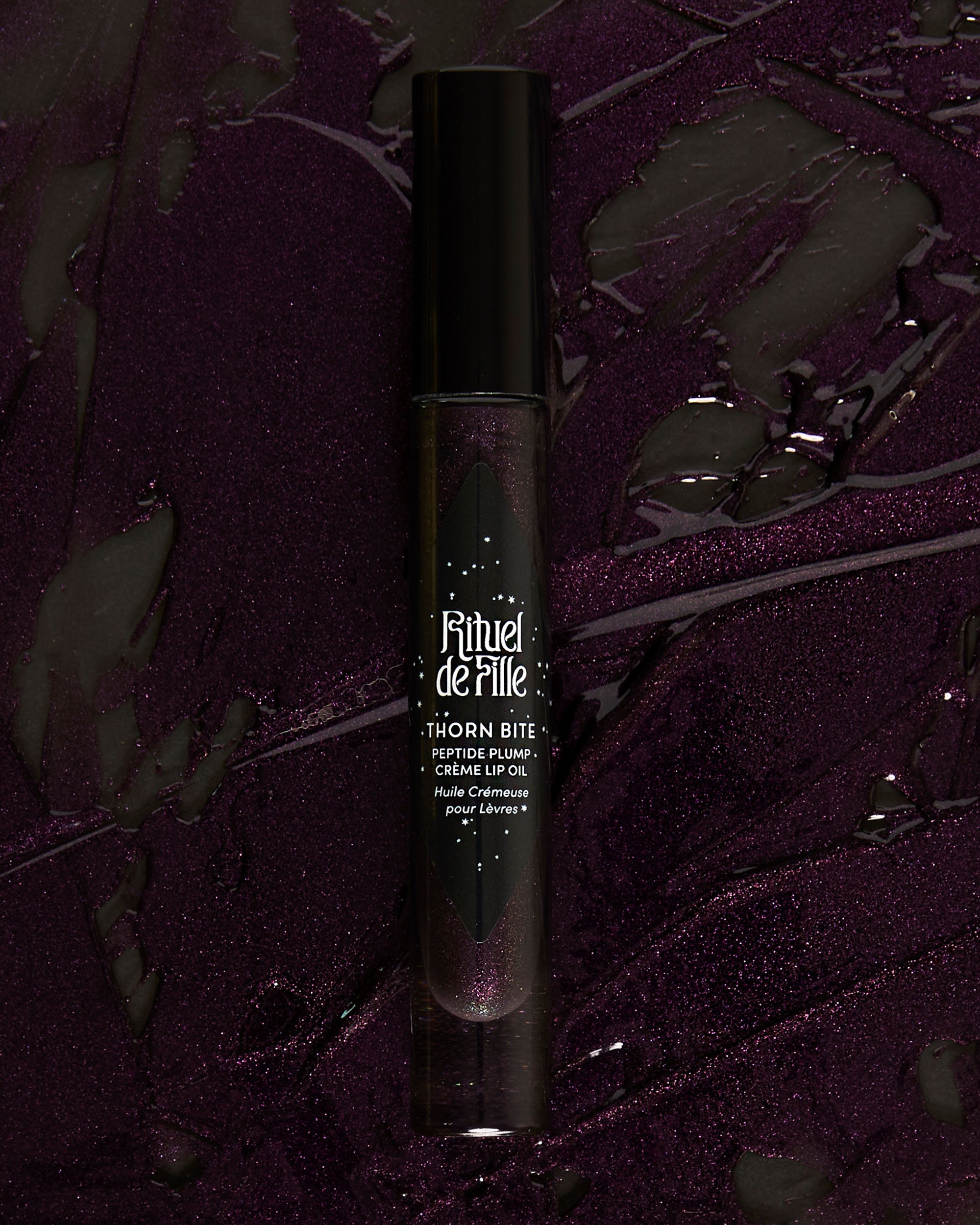 Campaign image featuring model wearing Night Bloom lip oil