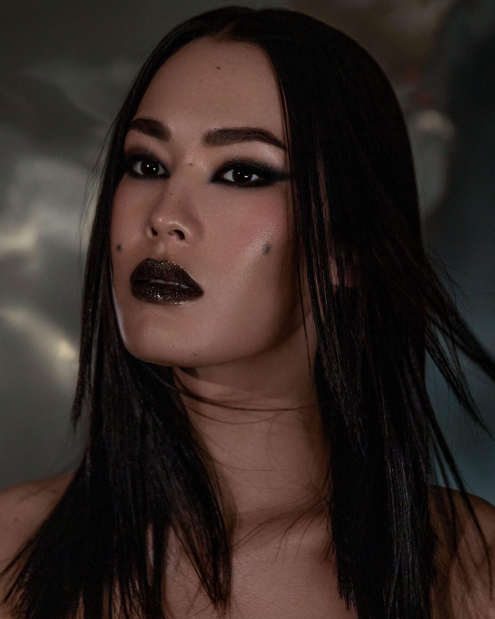 Model wearing Night Glow Thorn Bite lip oil shade