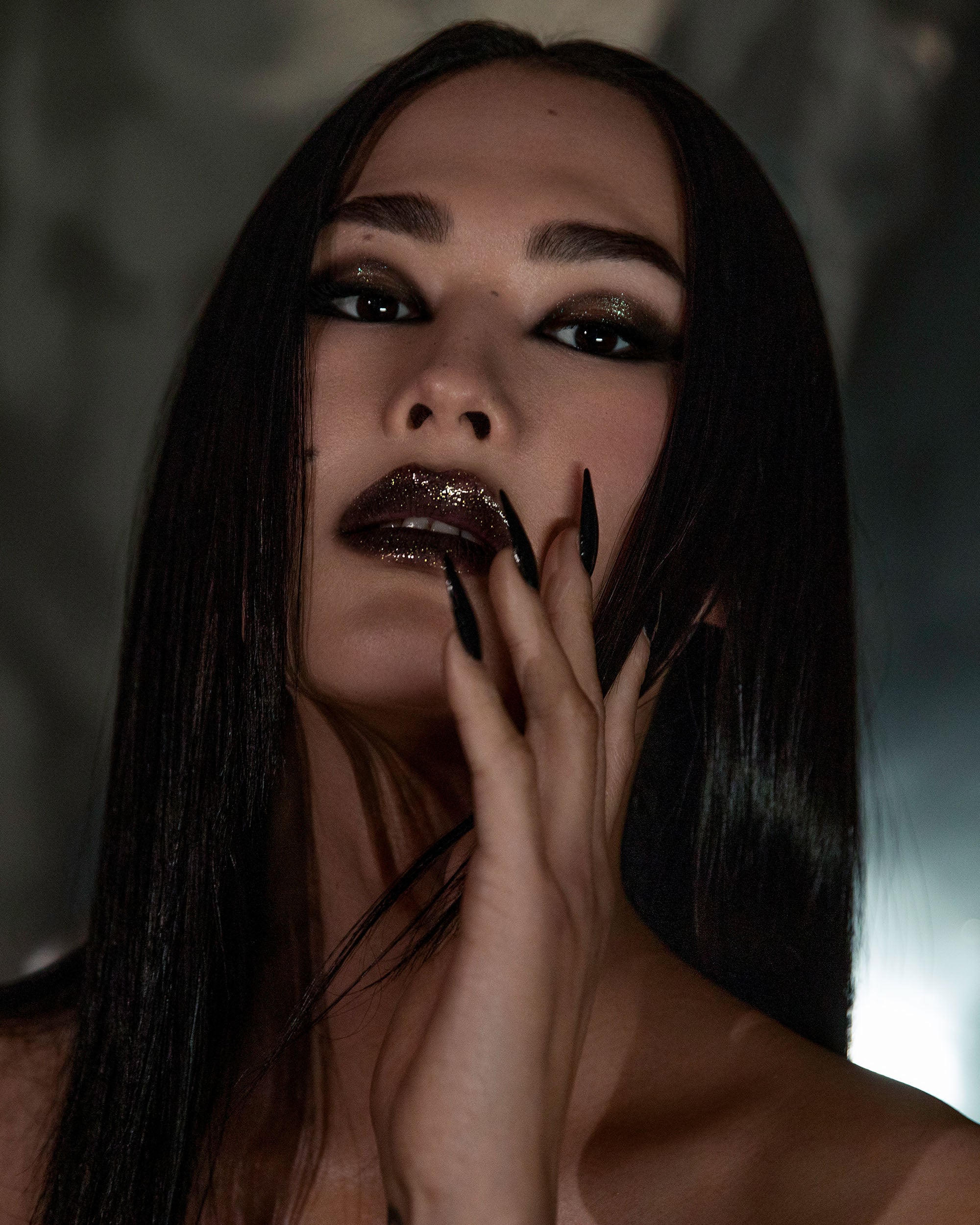 Model wearing Night Glow Thorn Bite lip oil shade