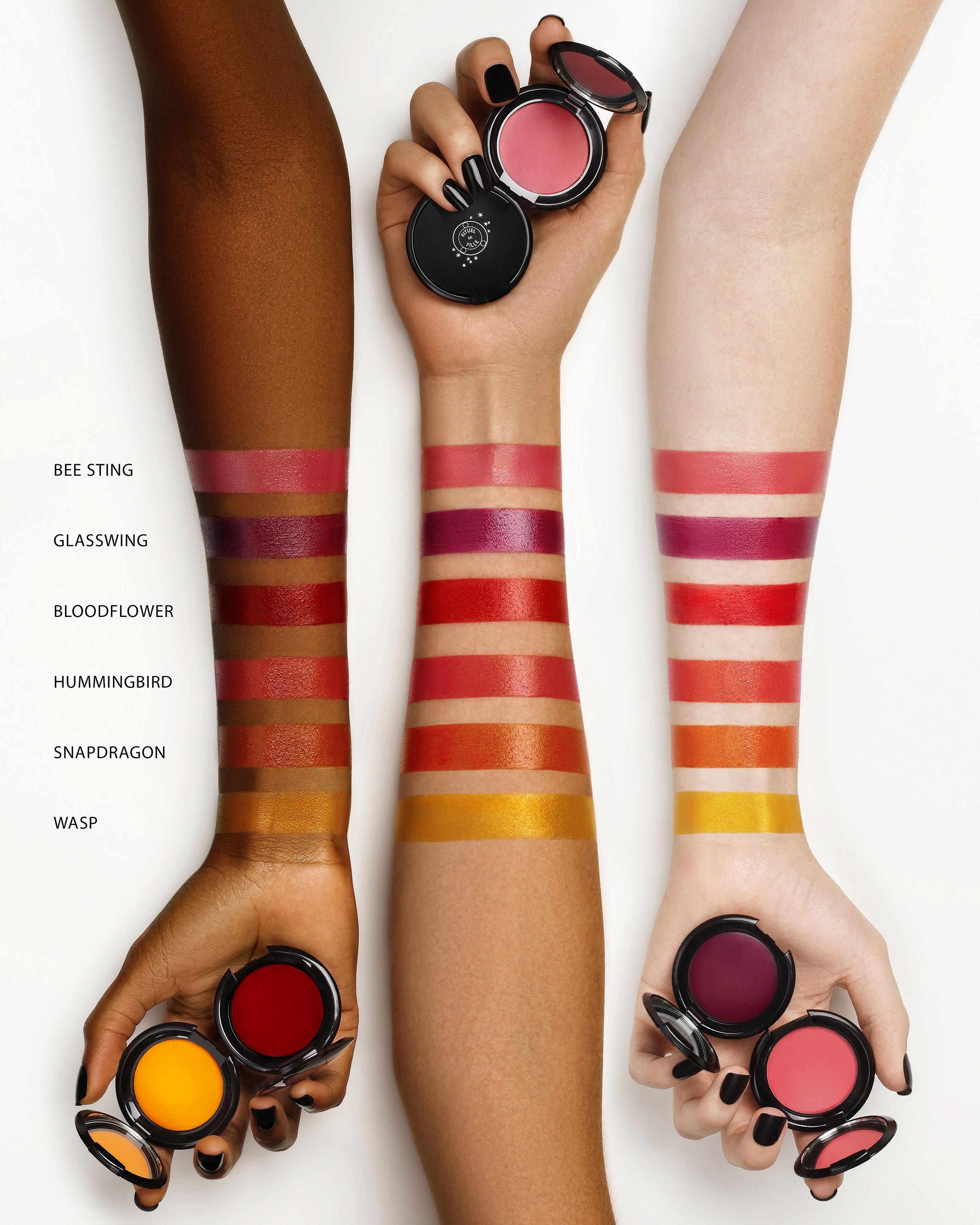 Color swatches on arms with makeup products labeled 'Bee Sting', 'Glasswing', 'Bloodflower', 'Hummingbird', 'Snapdragon', and 'Wasp'.