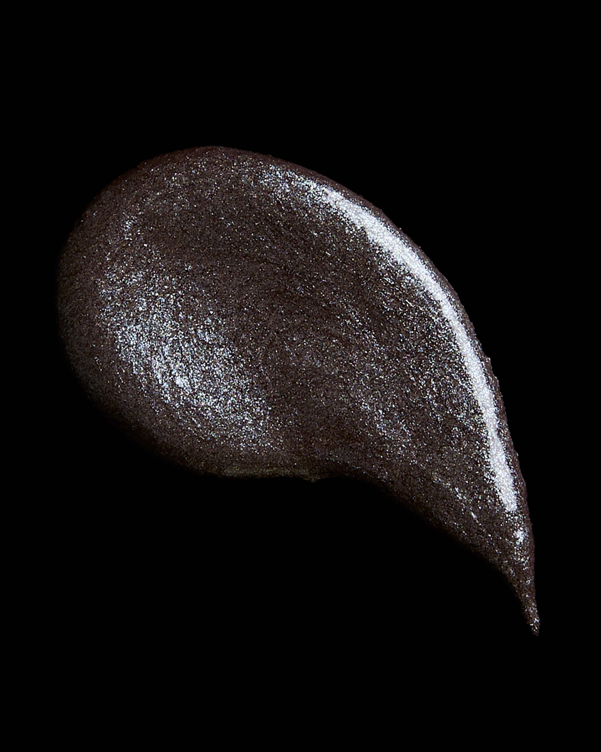 Dark gray smear of cream eyeshadow on a black background