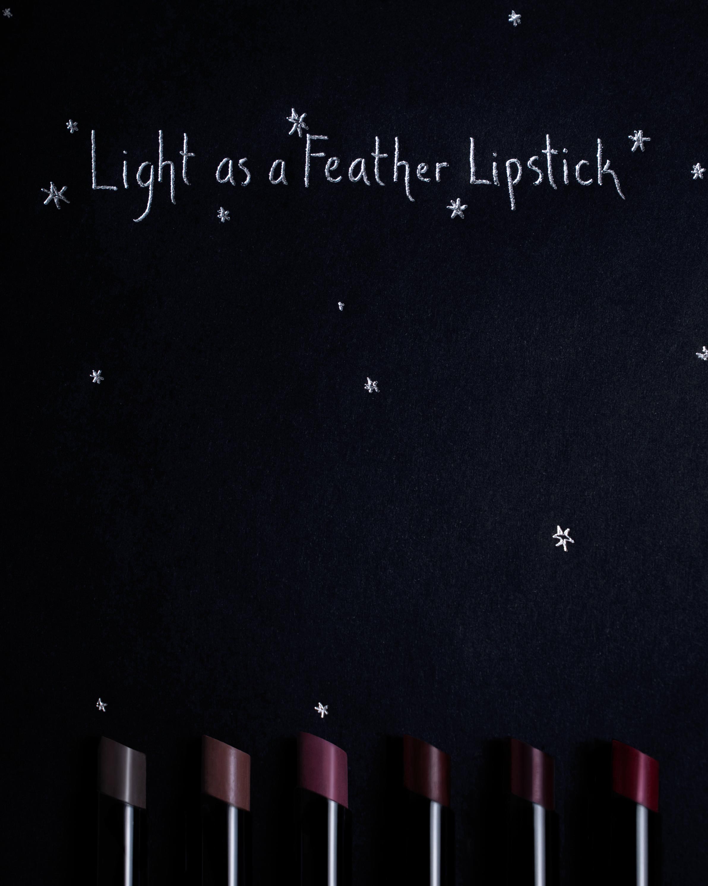 Lipstick set with 'Light as a Feather Lipstick' text on a dark background