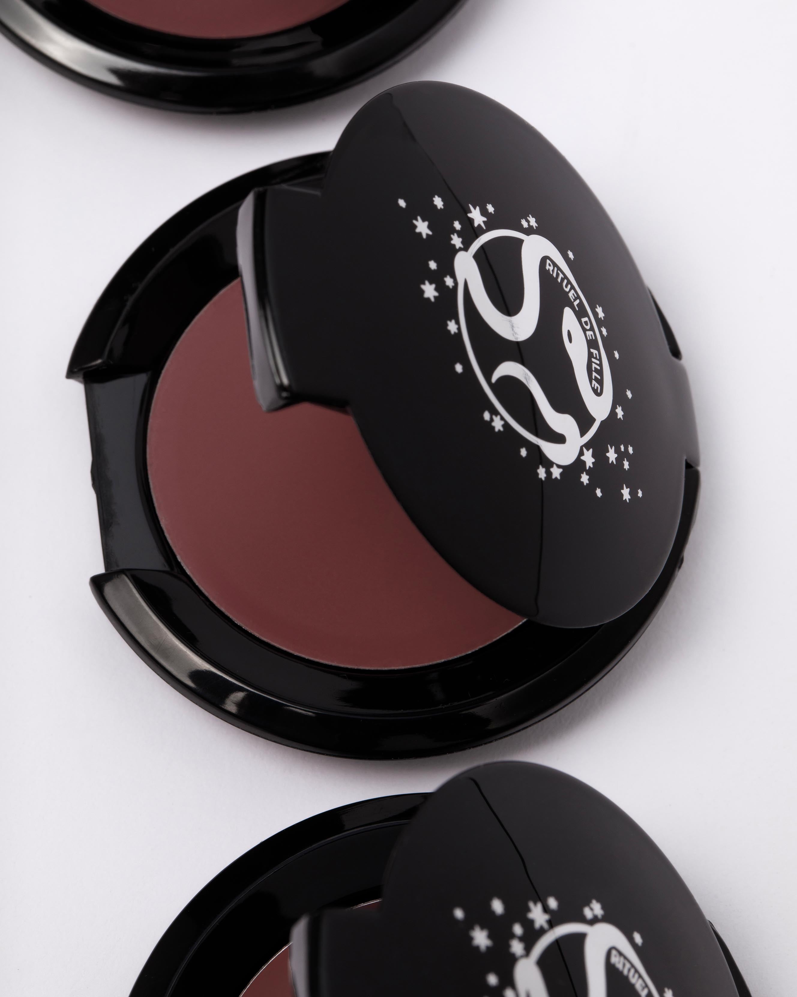 Makeup compacts with a nude pink makeup on a white background