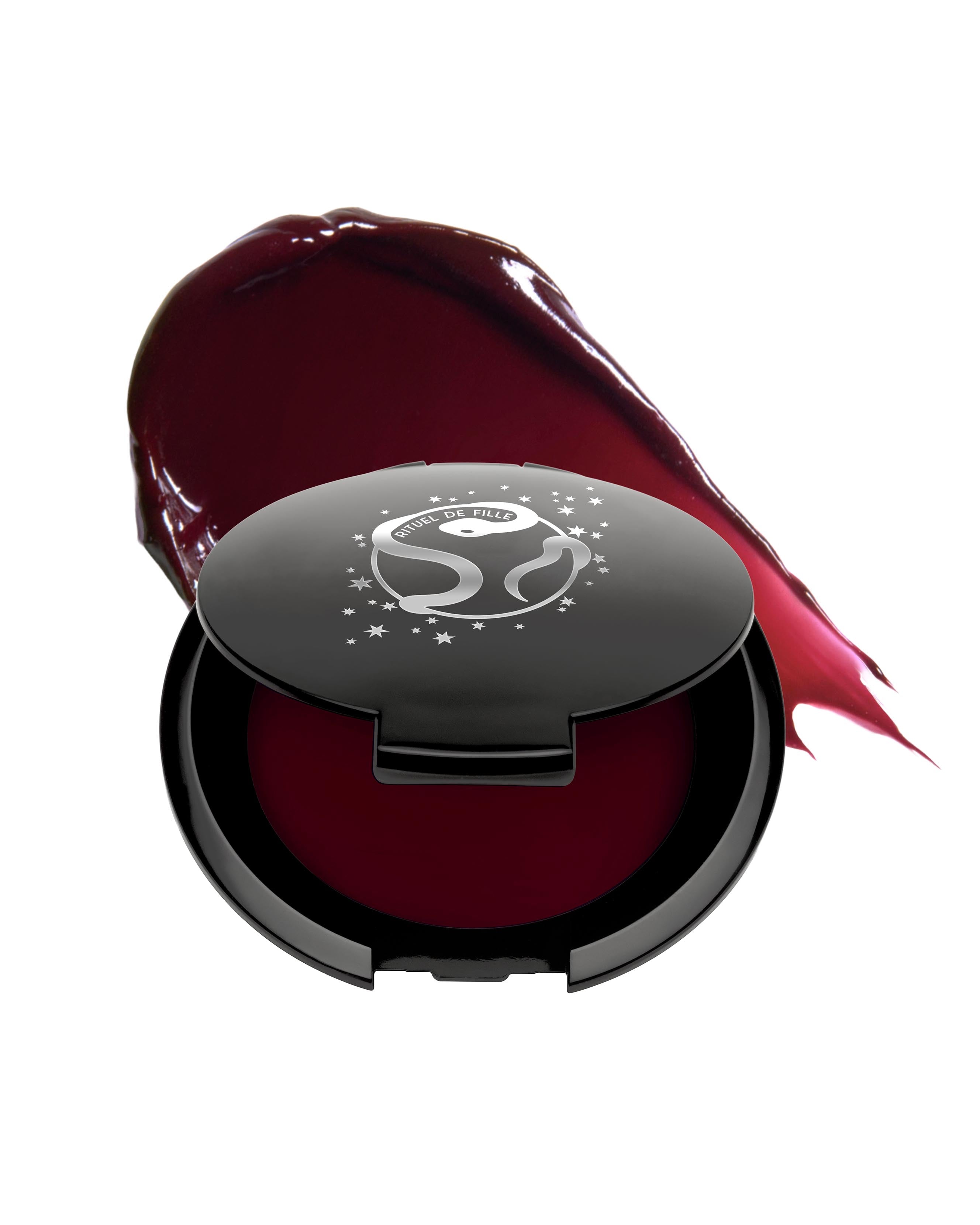 Burgundy red makeup in black compact with Rituel de Fille logo on a white background